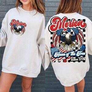 May include: White sweatshirt with a graphic print of an eagle with the words "Merica" and "Home of the Free Since 1776" on the back.