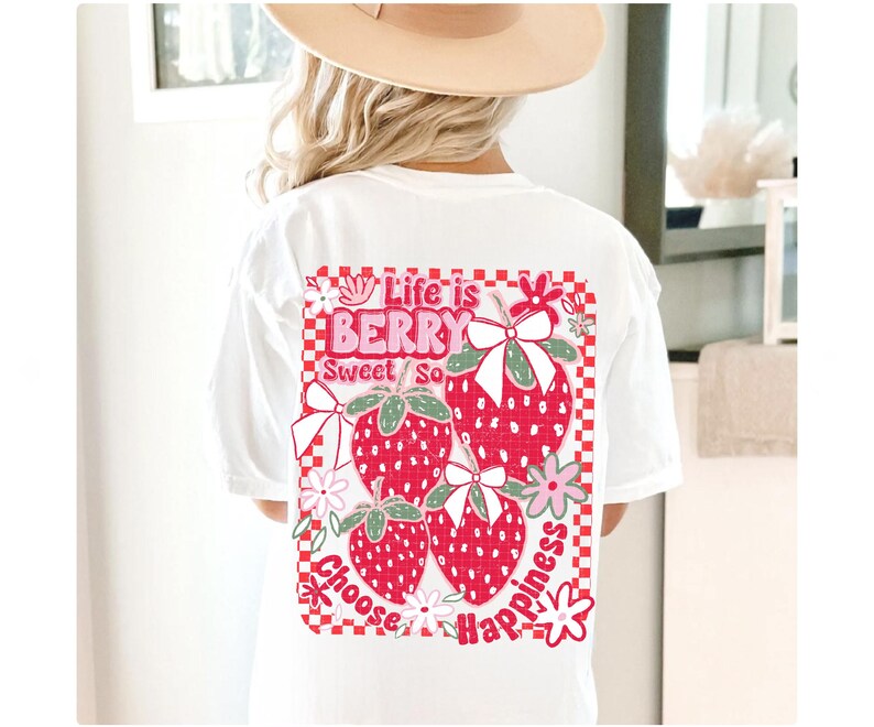 May include: White t-shirt with a red, pink, and green graphic print of strawberries and flowers. The graphic says "Life is Berry Sweet So Choose Happiness".