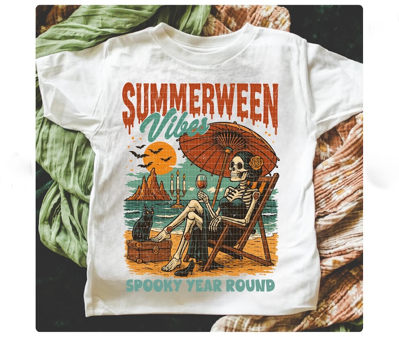 May include: White t-shirt with a colorful graphic featuring a skeleton relaxing on a beach chair under an umbrella, holding a glass of wine. The text reads "SUMMERWEEN VIBES" and "SPOOKY YEAR ROUND".