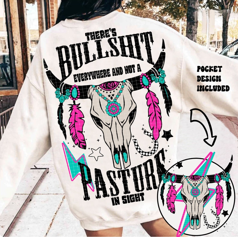 May include: White sweatshirt with a graphic design featuring a cow skull with turquoise and pink accents. The text "There's Bullshit Everywhere and Not a Pasture in Sight" is printed on the sweatshirt.