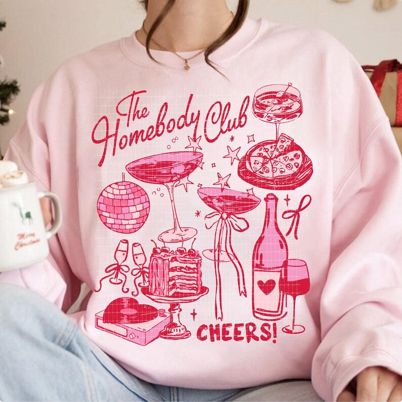 May include: Pink sweatshirt with a graphic design of a disco ball, drinks, cake, pizza, and the text "The Homebody Club Cheers!"