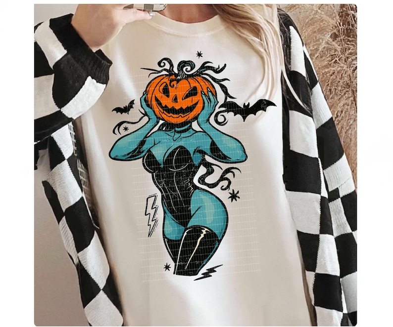 May include: Cream-colored sweatshirt featuring a Halloween-themed graphic. The design depicts a blue figure with a pumpkin head, wearing a black corset and boots. Bats and lightning bolts are also included in the design. The sleeves are black and white checkered.