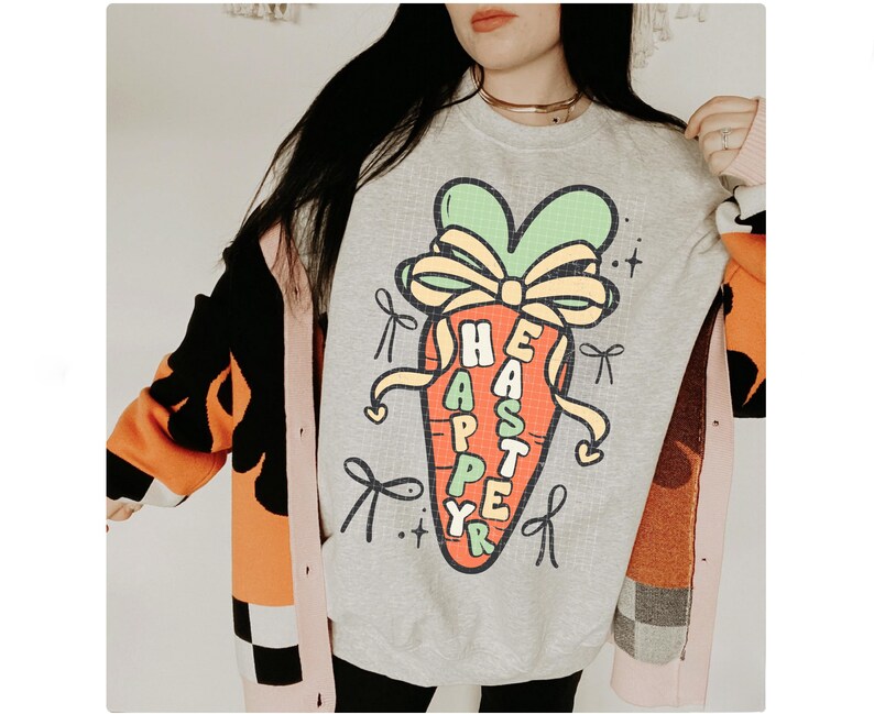 May include: A gray sweatshirt with a cartoon carrot wearing a bow and the text "Happy Easter" on it. The sweatshirt is being worn by a person with long dark hair.