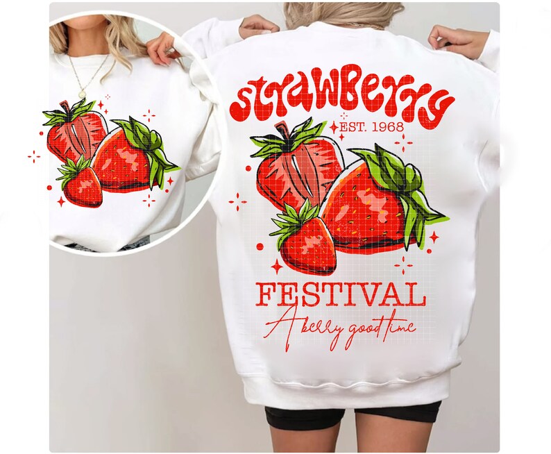 May include: White sweatshirt with a red and green strawberry graphic and the text "Strawberry Festival A berry good time" and "EST. 1968".