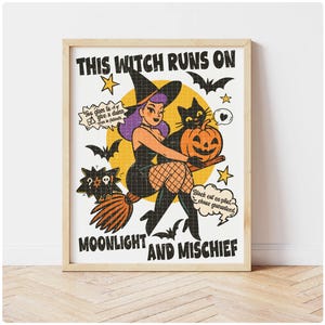 May include: A framed print with a retro illustration of a witch and a black cat. The witch is holding a pumpkin. Text includes "THIS WITCH RUNS ON MOONLIGHT AND MISCHIEF" and speech bubbles with additional text.