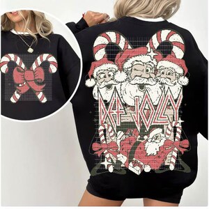May include: Black sweatshirt with a Christmas-themed graphic featuring three Santa Clauses with candy canes and the text "Def Jolly".