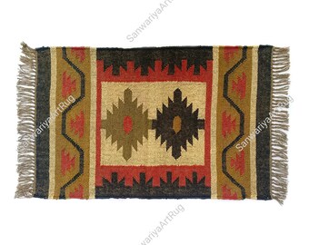 May include: A rectangular jute rug with a geometric pattern in shades of brown, black, red, and beige. The rug has fringe on all four sides.
