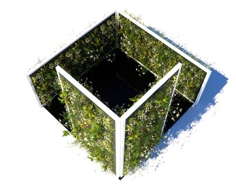 May include: A white cube-shaped structure with a black interior. The exterior of the cube is covered in green plants and white flowers.