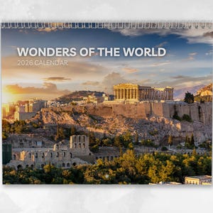 May include: A 2026 calendar with a spiral binding, displaying a sunset view of the Acropolis in Athens, Greece. The calendar is titled "Wonders of the World". The image shows the ancient structures set against a vibrant, colorful sky.