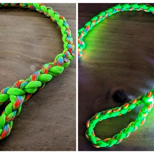 May include: A neon green braided leash with sections of rainbow-colored strands. The leash is made of a durable material and is designed for pets. The image shows the leash in two different views, highlighting its vibrant colors and construction.