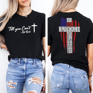 May include: Black t-shirt with the text "Till you Can't - Kid Rock" and a white cross on the front. The back features a cross design with the American flag and the word "JESUS" and song lyrics.