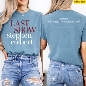 May include: Baby blue t-shirt with the text "the LAST SHOW with stephen colbert" in maroon and white. The back of the shirt has the text "05.21.2026 The Night The Laughter Died" in white.