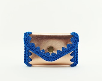 Handmade gold leather purse with blue cord crocheted edge.