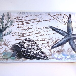 May include: Rectangular decorative tray with a coastal theme. The tray features a starfish, seashell, and coral design in shades of blue, gray, and white. The background includes script and a postage stamp. The number "263-5" is printed on the bottom right.