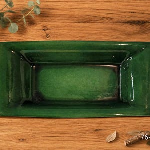 May include: A rectangular ceramic tray with a glossy, deep emerald green glaze and dark, shadowed edges. The tray features a smooth, reflective surface with a slightly raised rim and a flat base. The text 76-BWS is printed in the bottom right corner.