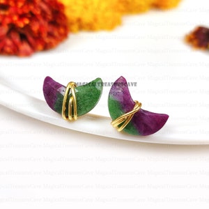 Könnte beinhalten: Ein Paar Halbmond-Ohrringe aus grünen und violetten Edelsteinen, die mit goldfarbenem Draht umwickelt sind.