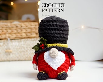 May include: Crochet pattern for a Christmas gnome. The gnome is red with a white beard and a black hat with a green holly sprig and red berries.