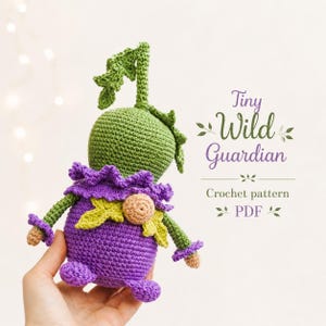 May include: A handmade crochet doll in shades of green and purple. The doll has a round green head with a leafy top, a purple body, and small arms and legs. The text "Tiny Wild Guardian" and "Crochet pattern PDF" are visible.