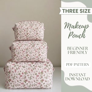 May include: Three floral print makeup pouches in varying sizes stacked on top of each other. The pouches are quilted with a pink background and a pattern of small red and green flowers. Text on the right side reads "THREE SIZE", "Makeup Pouch", "BEGINNER FRIENDLY", "PDF PATTERN", and "INSTANT DOWNLOAD".