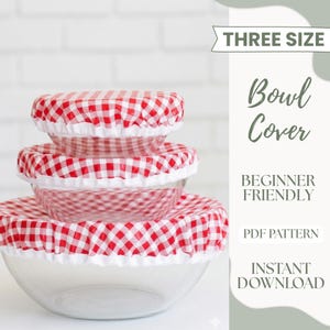 May include: Three clear glass bowls of varying sizes, each covered with a red and white checkered fabric lid. The lids have a white ruffled edge. Text on the side reads "THREE SIZE" and "Bowl Cover".