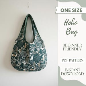 May include: A green hobo bag with a botanical print of white and tan leaves and flowers. The bag has a dark green trim and handle. Text on the image reads "One Size", "Hobo Bag", "Beginner Friendly", "PDF Pattern", and "Instant Download".