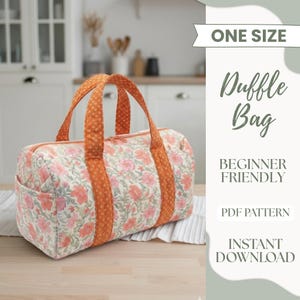 May include: A floral-patterned duffle bag with orange handles and accents. The bag features a cream background with pink and peach flowers. The text on the image reads "ONE SIZE", "Duffle Bag", "BEGINNER FRIENDLY", "PDF PATTERN", and "INSTANT DOWNLOAD".