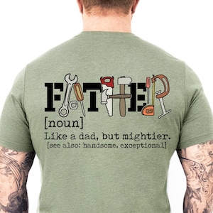 May include: A green t-shirt with the word "FATHER" spelled out in black letters with tools incorporated into the letters. The definition of "father" is written below the word, "[noun] Like a dad, but mightier. [see also: handsome, exceptional]"