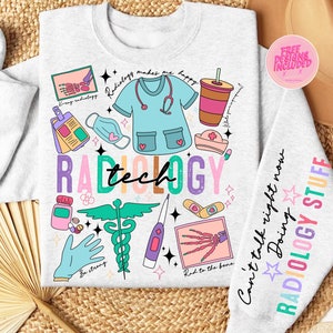 May include: A light grey sweatshirt with a colourful graphic design featuring the words "Radiology Tech" and various medical-themed illustrations, including a stethoscope, a heart, a bandage, a hand skeleton, and a medical symbol. The text "Can't talk right now Doing RADIOLOGY STUFF" is printed on the right sleeve.