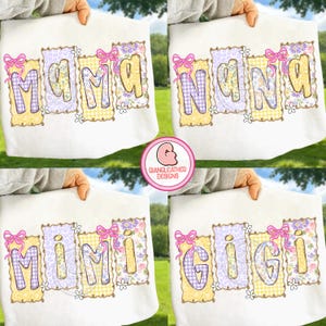 May include: White t-shirts with the words "MAMA", "NANA", "MIMI", and "GIGI" in colorful, decorative lettering. Each word is framed with a floral and gingham pattern, and topped with a pink bow. The shirts are held up against a green background.