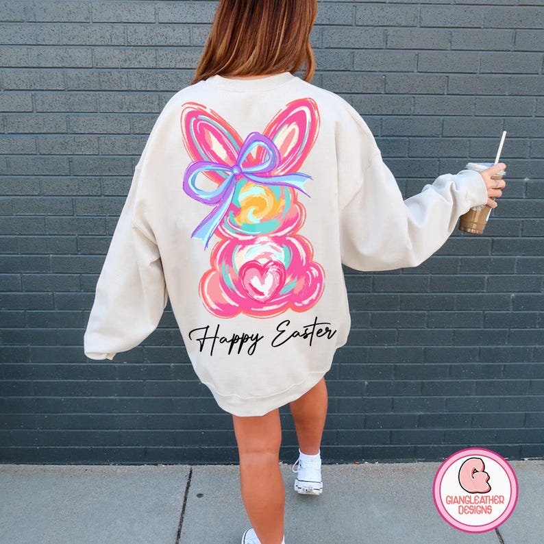 May include: A cream-colored sweatshirt with a colorful abstract bunny design and the text "Happy Easter" on the back.