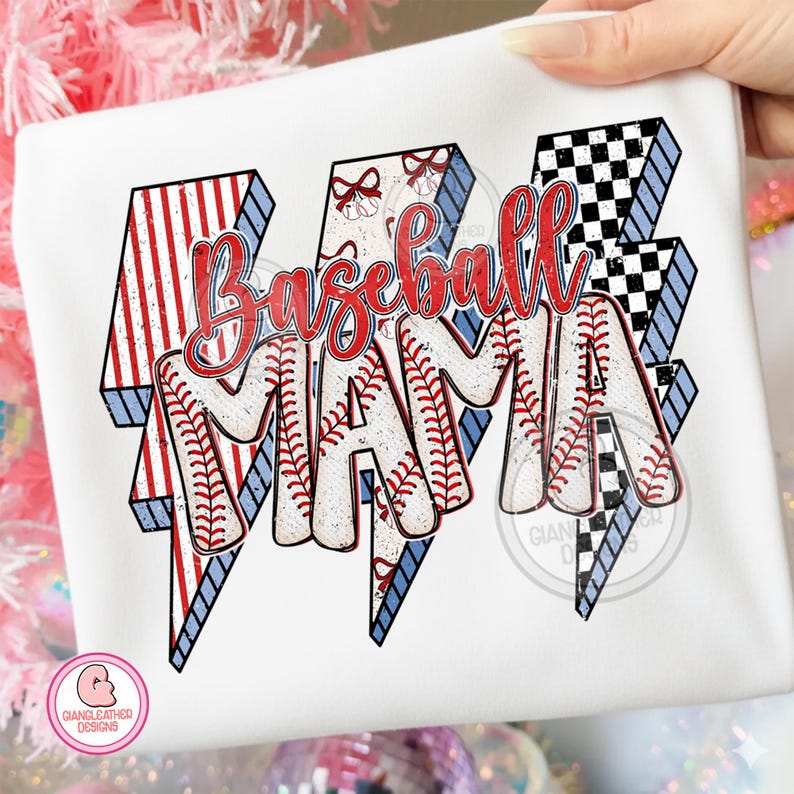 May include: White t-shirt with a "Baseball Mama" design. The text is in red, with baseball stitching details. The design includes red and white striped and checkered lightning bolt shapes with blue outlines.