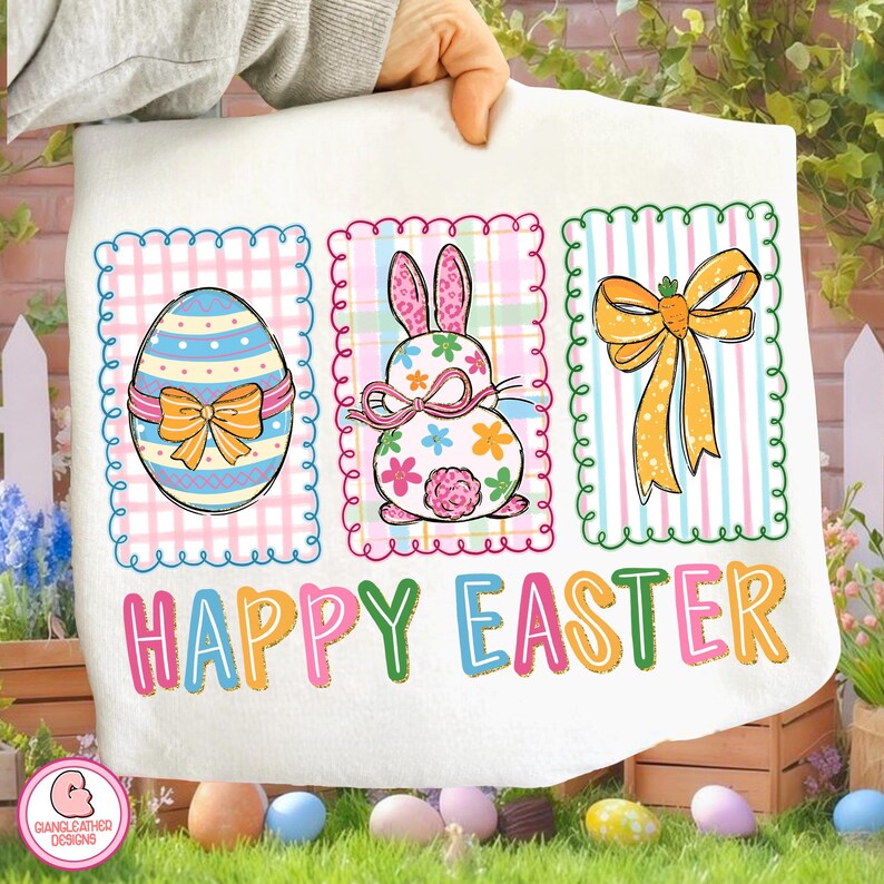 May include: A white Easter-themed towel featuring three colorful panels. The panels display an Easter egg, a bunny, and a bow, all with decorative borders. The words "HAPPY EASTER" are printed across the bottom in bright colors.
