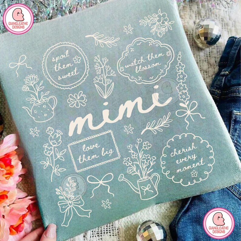 May include: A light blue fabric with white floral illustrations and the name "Mimi" in cursive. The design includes phrases like "spoil them sweet" and "cherish every moment".