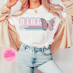 May include: White t-shirt with the word "MAMA" in rainbow colors and a butterfly graphic. The text "Loved, Hardworking, Selfless, Protective" is printed below the word "MAMA".
