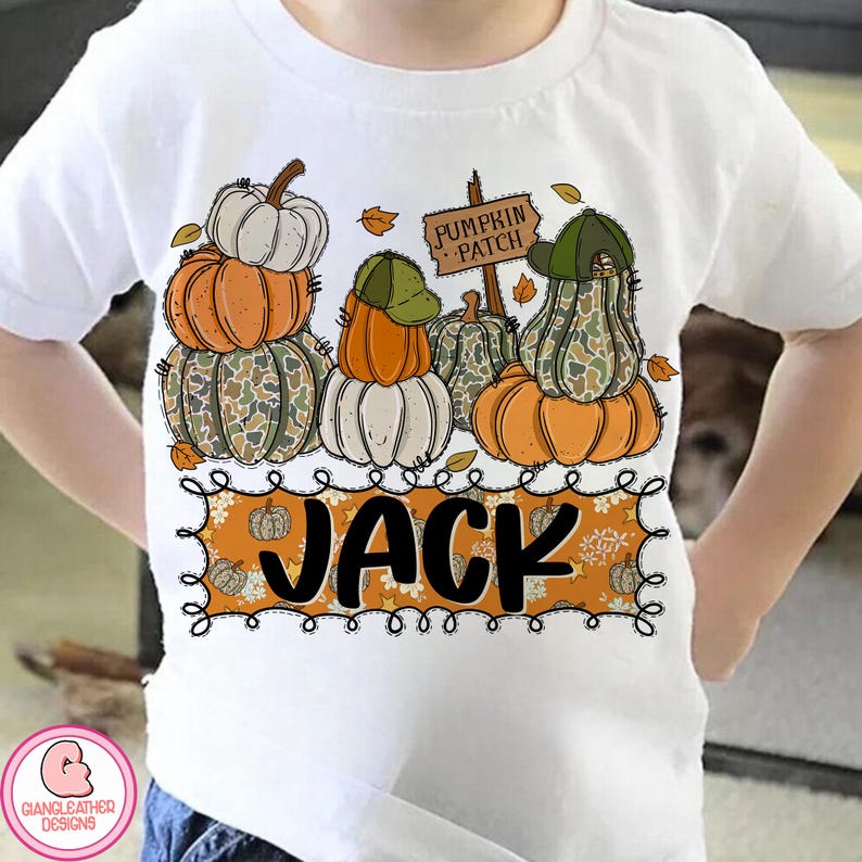 May include: White t-shirt featuring a stacked pumpkin design with orange, white, and camouflage pumpkins. The shirt has the name "JACK" in black letters on a decorative orange banner, with a "Pumpkin Patch" sign.