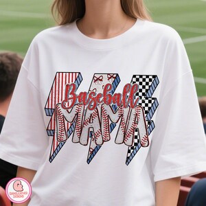 May include: White t-shirt with the text "Baseball Mama" in red script. The text is inside three lightning bolt shapes with red and white stripes, baseball stitching, and a black and white checkered pattern.