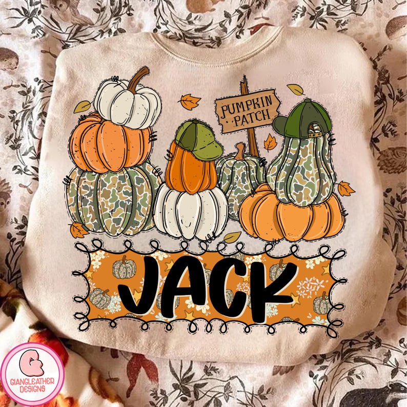 May include: Beige sweatshirt with a fall-themed graphic. The design features stacked pumpkins in orange, white, and camouflage patterns, some wearing green caps. A sign reads "Pumpkin Patch" and the name "JACK" is displayed below.