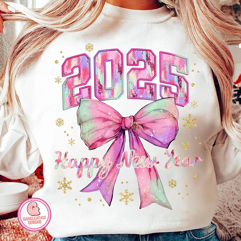 May include: White sweatshirt with a pink and purple 2025 design with a large pink and purple bow and the text "Happy New Year".