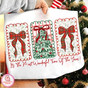 May include: White Christmas-themed fabric with three rectangular designs. Each design features a red plaid bow or a green Christmas tree with red ornaments. The text "It's The Most Wonderful Time Of The Year!" is written in red.