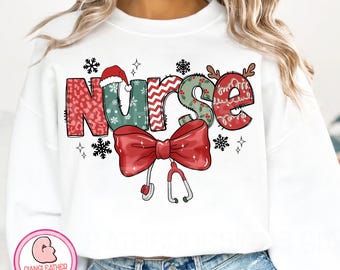 May include: White sweatshirt with a colorful Christmas-themed "NURSE" graphic. The letters are decorated with festive patterns, a Santa hat, reindeer antlers, snowflakes, and a red bow with a stethoscope.