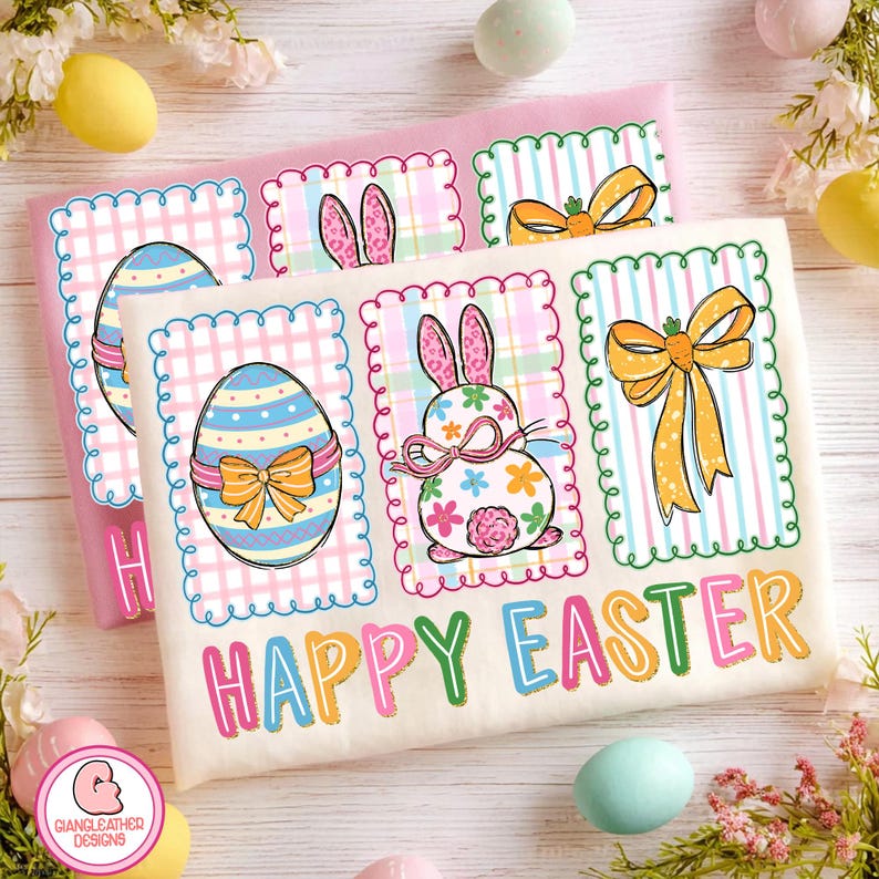 May include: Two Easter-themed shirts with colorful designs. One shirt is pink, the other is off-white. Each features three framed illustrations: an Easter egg, a bunny, and a bow. The words "HAPPY EASTER" are printed in colorful letters across the bottom.