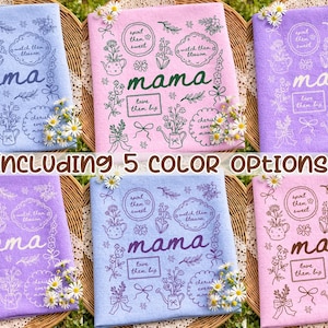 May include: A collection of five colorful decorative towels, each featuring the word "mama" in cursive, surrounded by floral illustrations and text. The towels are in shades of blue, pink, and purple, with the text "Including 5 COLOR OPTIONS" at the bottom.