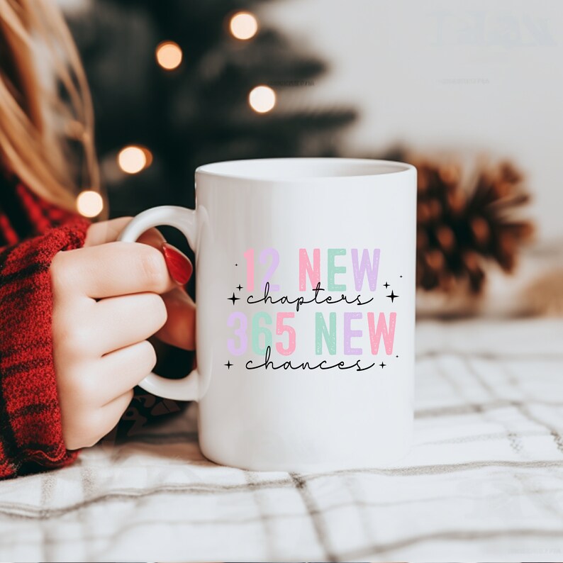 May include: White ceramic mug with a black inscription that reads "12 NEW chapters + 365 NEW chances +" in pink, purple, and green lettering.