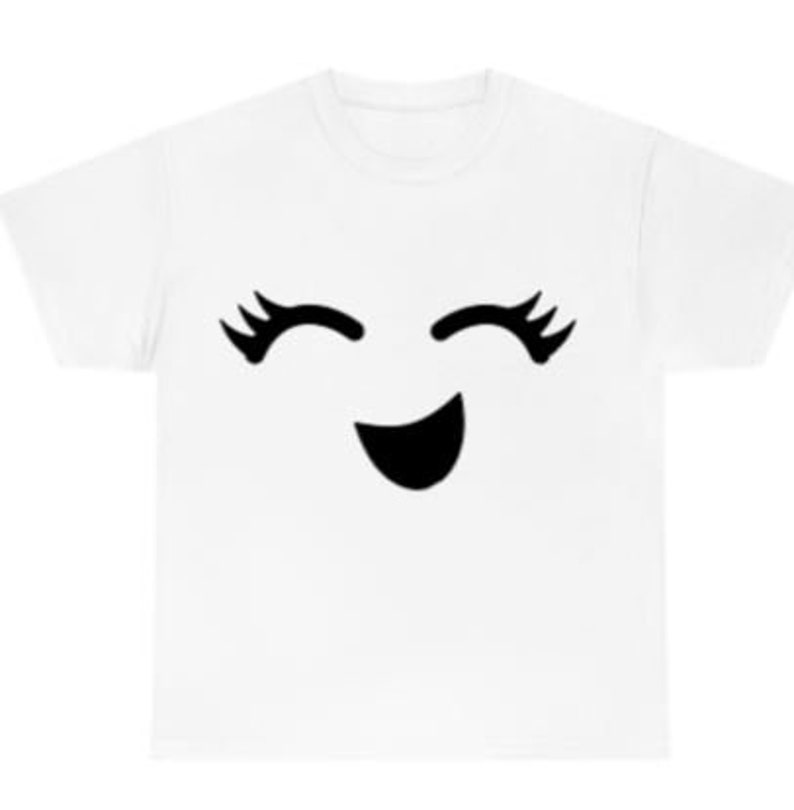 May include: White t-shirt with a black smiling face with eyelashes.