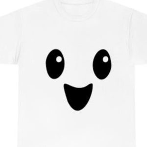 May include: White t-shirt with a black cartoon face with big eyes and a wide smile.