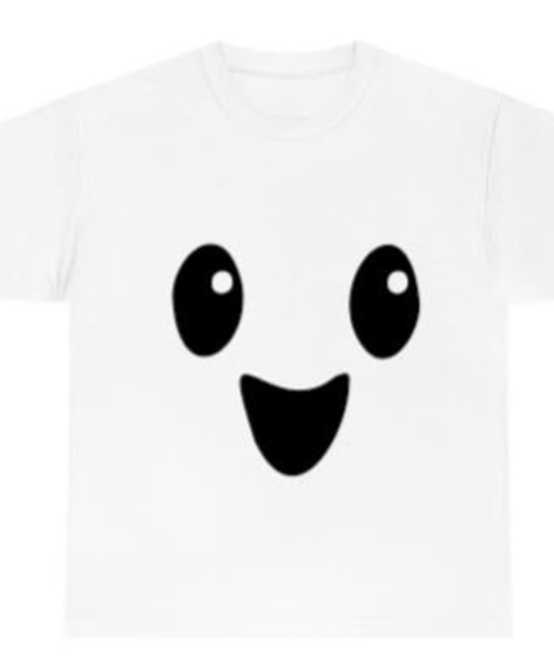 May include: White t-shirt with a black cartoon face with big eyes and a wide smile.