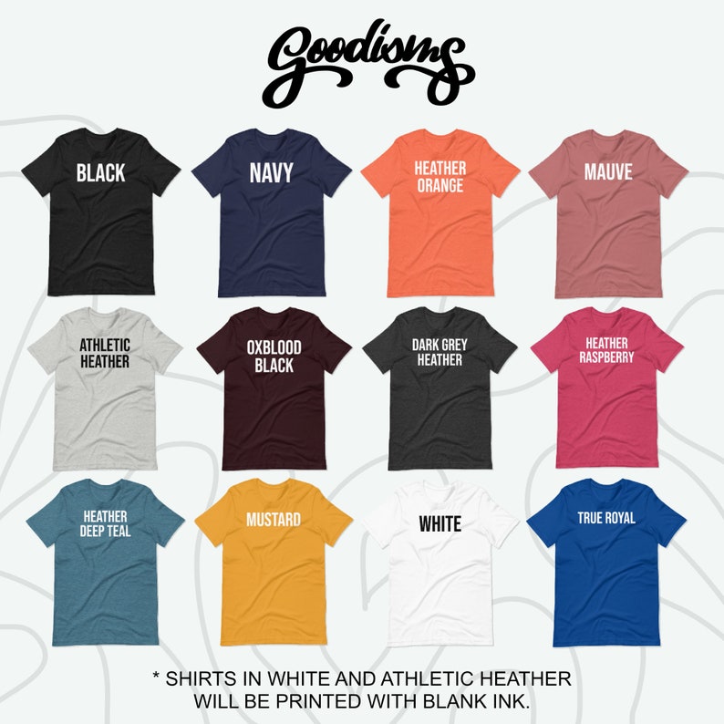 Puede incluir: Una selecci&oacute;n de camisetas de varios colores, incluyendo negro, azul marino, naranja jaspeado, malva, jaspeado atl&eacute;tico, negro oxblood, jaspeado gris oscuro, frambuesa jaspeado, azul teal jaspeado, mostaza, blanco y azul royal. El texto "Goodioms" est&aacute; en la parte superior de la imagen. El texto "* SHIRTS IN WHITE AND ATHLETIC HEATHER WILL BE PRINTED WITH BLANK INK." est&aacute; en la parte inferior de la imagen.