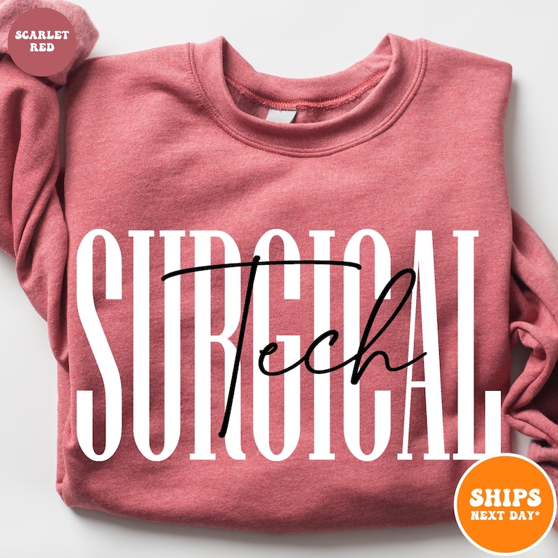 May include: A pink sweatshirt with the text "SURGICAL Tech" in white letters with a black cursive "Tech" on a pink sweatshirt.