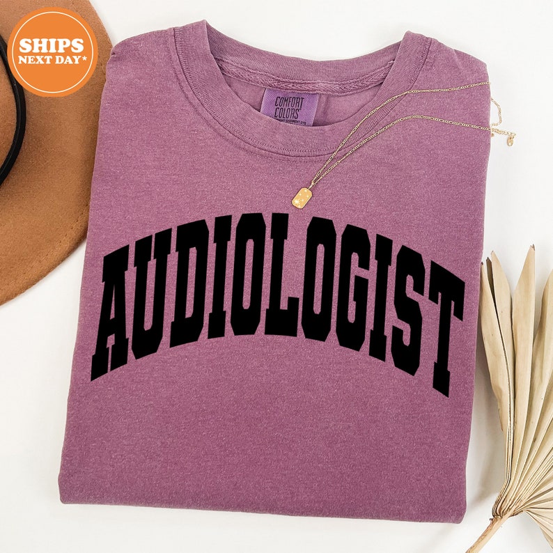 a purple shirt with the word audiologist on it