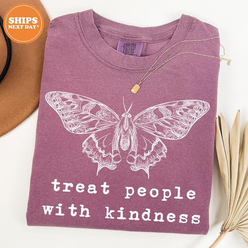 a purple shirt with a butterfly on it